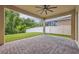 Covered patio with brick pavers, ceiling fan, and view of fenced yard at 14078 Alafaya Oak Bnd, Orlando, FL 32828