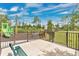 View of the fenced playground with a bench and play structures, offering a safe and fun community space at 14078 Alafaya Oak Bnd, Orlando, FL 32828
