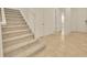 Tiled entryway featuring a carpeted staircase and multiple interior door access at 14078 Alafaya Oak Bnd, Orlando, FL 32828