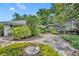 Landscaped backyard with stone pathway and enclosure at 1441 Sunnyside Dr, Maitland, FL 32751