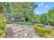 Sprawling backyard featuring winding stone pathway and mature landscaping at 1441 Sunnyside Dr, Maitland, FL 32751