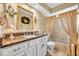 Bathroom with a vanity and granite countertops, a framed mirror, and a shower-tub combination at 1441 Sunnyside Dr, Maitland, FL 32751