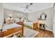 Cozy bedroom featuring two twin beds, a ceiling fan, and light gray walls and trim at 1441 Sunnyside Dr, Maitland, FL 32751