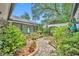 Brick-paved courtyard enhanced by greenery and a white privacy wall with a decorative trellis feature at 1441 Sunnyside Dr, Maitland, FL 32751