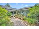 Serene brick-paved courtyard featuring lush landscaping and decorative trellis features for a calming outdoor space at 1441 Sunnyside Dr, Maitland, FL 32751