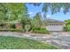 Charming single-story brick home with a well-manicured lawn, decorative gate and mature trees at 1441 Sunnyside Dr, Maitland, FL 32751