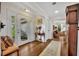 Bright foyer with hardwood floors and a view into a warmly decorated living area at 1441 Sunnyside Dr, Maitland, FL 32751