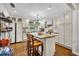 Bright kitchen with white cabinets, granite countertops, a center island and stainless steel appliances at 1441 Sunnyside Dr, Maitland, FL 32751