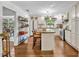 Well-lit kitchen featuring white cabinets, granite countertops, stainless steel appliances and a center island at 1441 Sunnyside Dr, Maitland, FL 32751