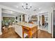 Bright kitchen with white cabinetry, granite countertops, and hardwood flooring overlooks living area at 1441 Sunnyside Dr, Maitland, FL 32751