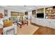 Bright living room with hardwood floors, built-in cabinets, and large windows at 1441 Sunnyside Dr, Maitland, FL 32751