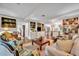 Bright living room with hardwood floors, built-in cabinets and open access to the kitchen at 1441 Sunnyside Dr, Maitland, FL 32751