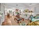 Bright living room with hardwood floors, white walls and open access to the kitchen at 1441 Sunnyside Dr, Maitland, FL 32751