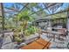 Enclosed patio featuring grilling station and room for dining among mature plants at 1441 Sunnyside Dr, Maitland, FL 32751
