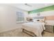 Cozy bedroom featuring carpet floors and a picture window for natural light at 14655 Erice Ave, Clermont, FL 34714