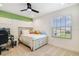 Bright bedroom with a large window, ceiling fan, and neutral carpet at 14655 Erice Ave, Clermont, FL 34714