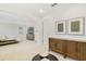 Open bedroom layout featuring carpet flooring, neutral walls, and an ensuite bathroom, cabinets, and drawers at 14655 Erice Ave, Clermont, FL 34714