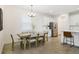 Dining area adjacent to kitchen includes modern table with seating and stylish lighting at 14655 Erice Ave, Clermont, FL 34714
