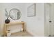 Bright foyer features a modern console table, round mirror, and stylish decor at 14655 Erice Ave, Clermont, FL 34714