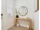 Bright foyer features a modern console table, round mirror, and stylish decor at 14655 Erice Ave, Clermont, FL 34714