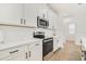 Modern kitchen with white cabinets, stainless steel appliances, and sleek countertops at 14655 Erice Ave, Clermont, FL 34714