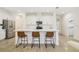 Bright kitchen featuring an island with seating, stainless appliances, and white cabinetry at 14655 Erice Ave, Clermont, FL 34714