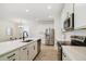 Bright kitchen with white quartz countertops, stainless steel appliances, and an open layout at 14655 Erice Ave, Clermont, FL 34714