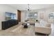 Inviting living room featuring modern sofas, sleek furniture, and large window at 14655 Erice Ave, Clermont, FL 34714