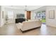 Modern living room with a sleek TV, stylish furniture, and sliding glass doors to the yard at 14655 Erice Ave, Clermont, FL 34714