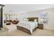 Spacious main bedroom with a bed, sitting area, carpet flooring, and natural light from the window at 14655 Erice Ave, Clermont, FL 34714