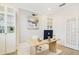 Modern office with stylish desk, white brick accent wall, decor, and a light-filled atmosphere at 14655 Erice Ave, Clermont, FL 34714