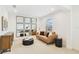 Stylish sitting room with modern decor, comfortable seating, and a decorative mirror wall at 14655 Erice Ave, Clermont, FL 34714