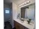 Bathroom with wood cabinets, countertop basin, and shower at 14936 Masthead Landing Cir, Winter Garden, FL 34787