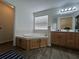 Bathroom featuring a soaking tub with wood cabinets at 14936 Masthead Landing Cir, Winter Garden, FL 34787