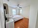 Cozy bedroom showcasing hardwood flooring, a fan, and natural lighting at 14936 Masthead Landing Cir, Winter Garden, FL 34787
