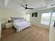 Spacious bedroom showcasing tray ceiling, plush carpet, and ambient bedside lighting at 14936 Masthead Landing Cir, Winter Garden, FL 34787
