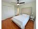 Bright bedroom featuring hardwood flooring, a fan, and a cushioned headboard at 14936 Masthead Landing Cir, Winter Garden, FL 34787