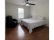 Bright bedroom featuring hardwood flooring, a fan, and a comfortable recliner at 14936 Masthead Landing Cir, Winter Garden, FL 34787