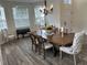 Bright dining room features wood-look floors, natural light and piano at 14936 Masthead Landing Cir, Winter Garden, FL 34787
