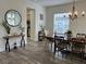 The dining room boasts wood-look flooring, decor, and natural light at 14936 Masthead Landing Cir, Winter Garden, FL 34787