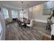 Open dining room with wood-look floors, decor, chandelier, and ample seating at 14936 Masthead Landing Cir, Winter Garden, FL 34787