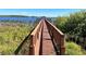 A long wooden dock leads to a covered gazebo over the beautiful lake water at 14936 Masthead Landing Cir, Winter Garden, FL 34787