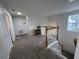Upstairs hallway with carpet, stairwell and natural light from window at 14936 Masthead Landing Cir, Winter Garden, FL 34787