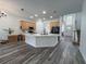 Open kitchen featuring a center island, wood cabinetry, and modern appliances near a staircase at 14936 Masthead Landing Cir, Winter Garden, FL 34787