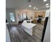 Spacious kitchen with a large island and stainless appliances, connecting to an adjacent area at 14936 Masthead Landing Cir, Winter Garden, FL 34787