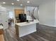 Bright kitchen showcasing an island with a sink and a view of the staircase at 14936 Masthead Landing Cir, Winter Garden, FL 34787