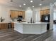 Spacious kitchen with a large center island, stainless steel appliances, and wood-look floors at 14936 Masthead Landing Cir, Winter Garden, FL 34787