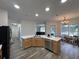 Bright, open kitchen with center island and wood-look flooring, adjacent to dining area at 14936 Masthead Landing Cir, Winter Garden, FL 34787