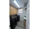 Functional laundry room with front loading washer and dryer and storage at 14936 Masthead Landing Cir, Winter Garden, FL 34787