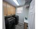 Laundry room with front loading washer and dryer plus storage space at 14936 Masthead Landing Cir, Winter Garden, FL 34787